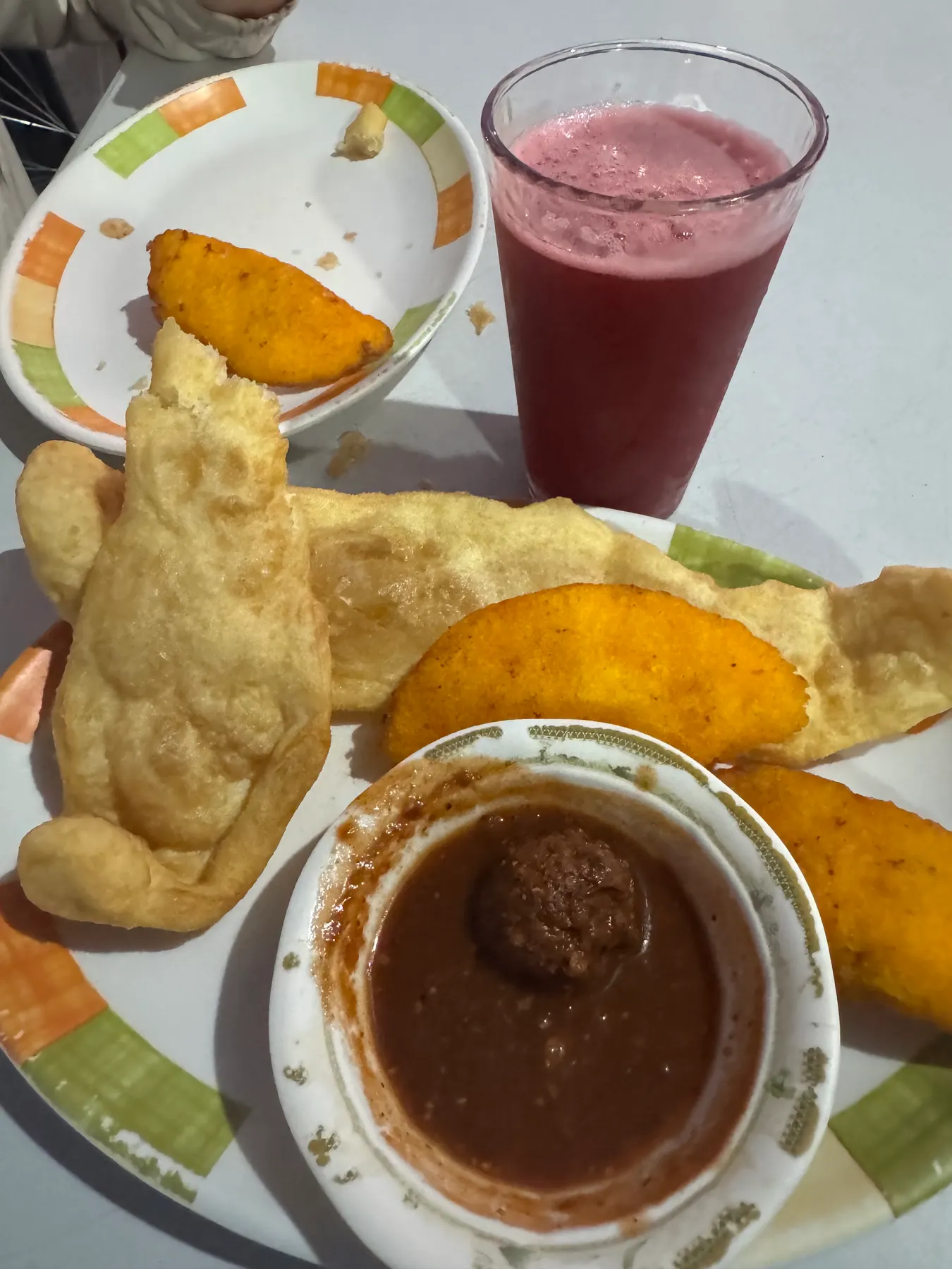 Corn empanadas and hojaldras, Panamanian fried bread, with a dipping sauce and fresh juice at a fonda in Boquete