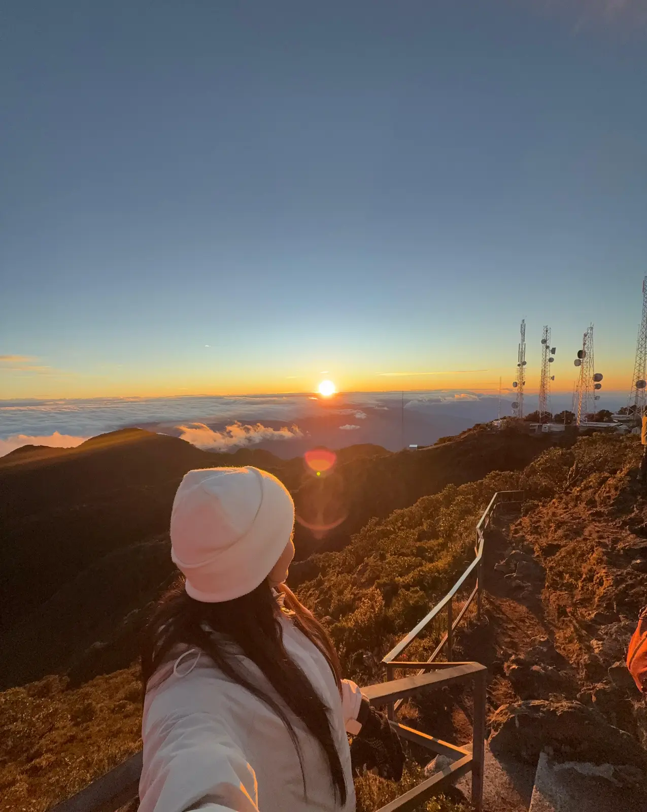 A traveller watching sunrise from the summit of Volcán Barú