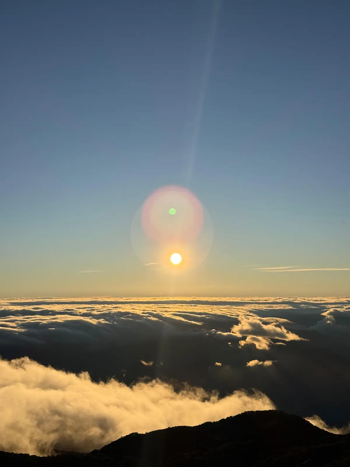 Sunrise breaking over a sea of clouds from the summit of Volcán Barú