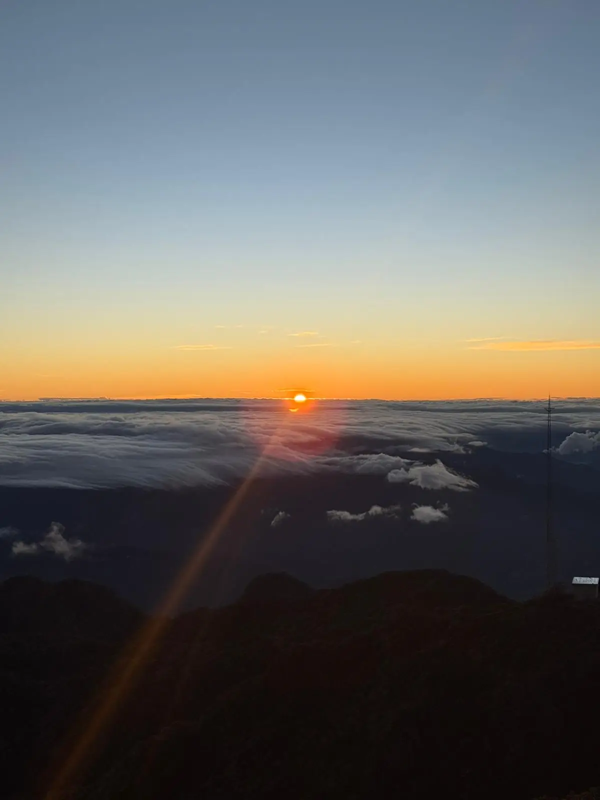 The sun rising above the clouds from the top of Volcán Barú
